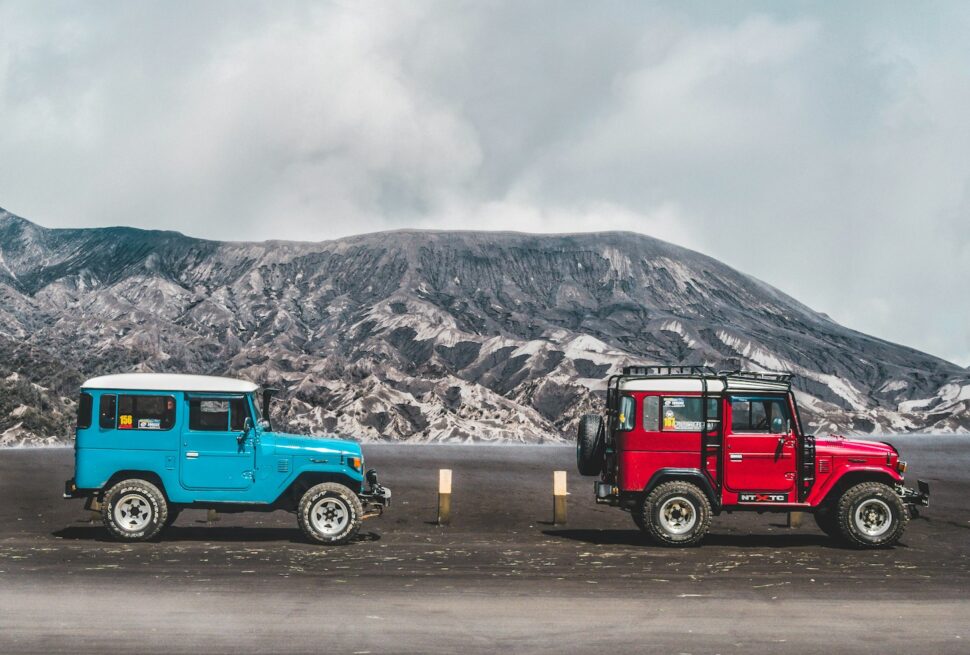 two blue and red SUV's near mountain