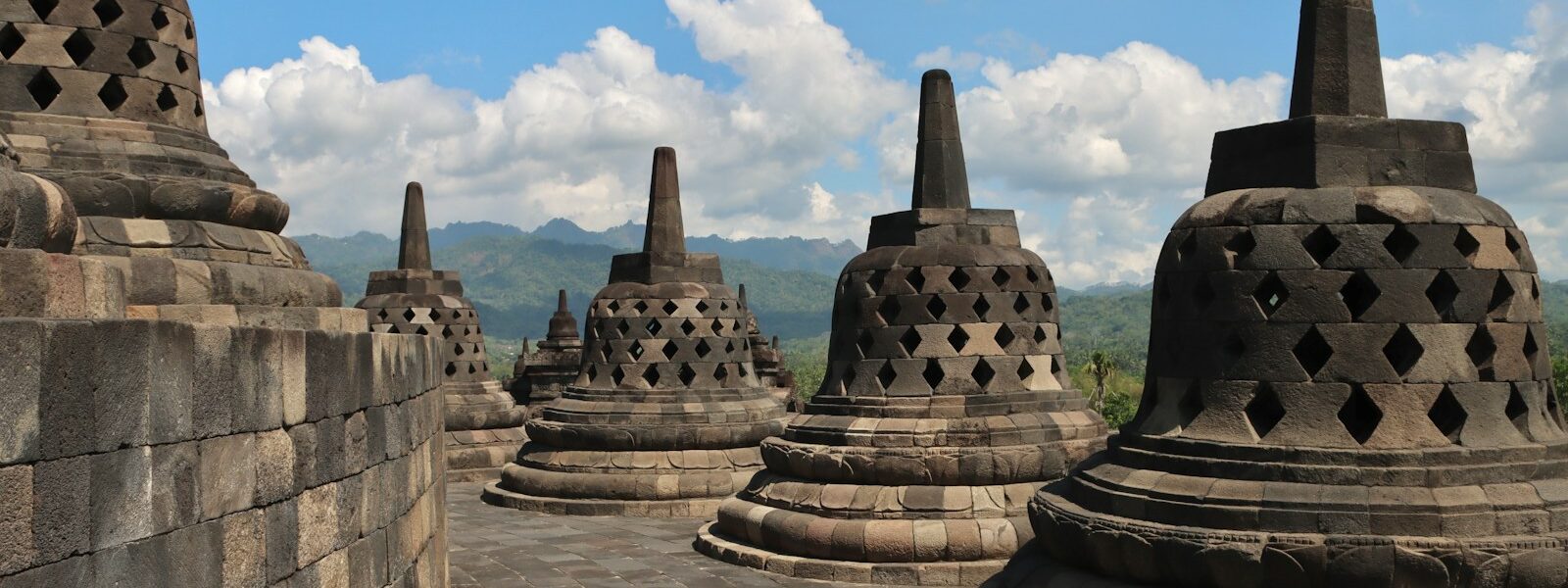 a group of stone structures sitting on top of a stone wall