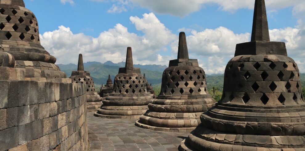 a group of stone structures sitting on top of a stone wall