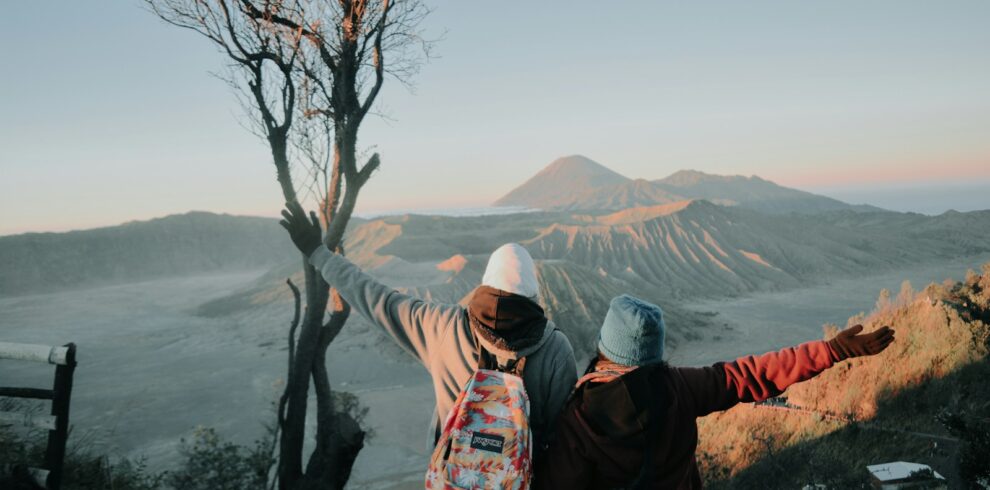 two person looking at mountains