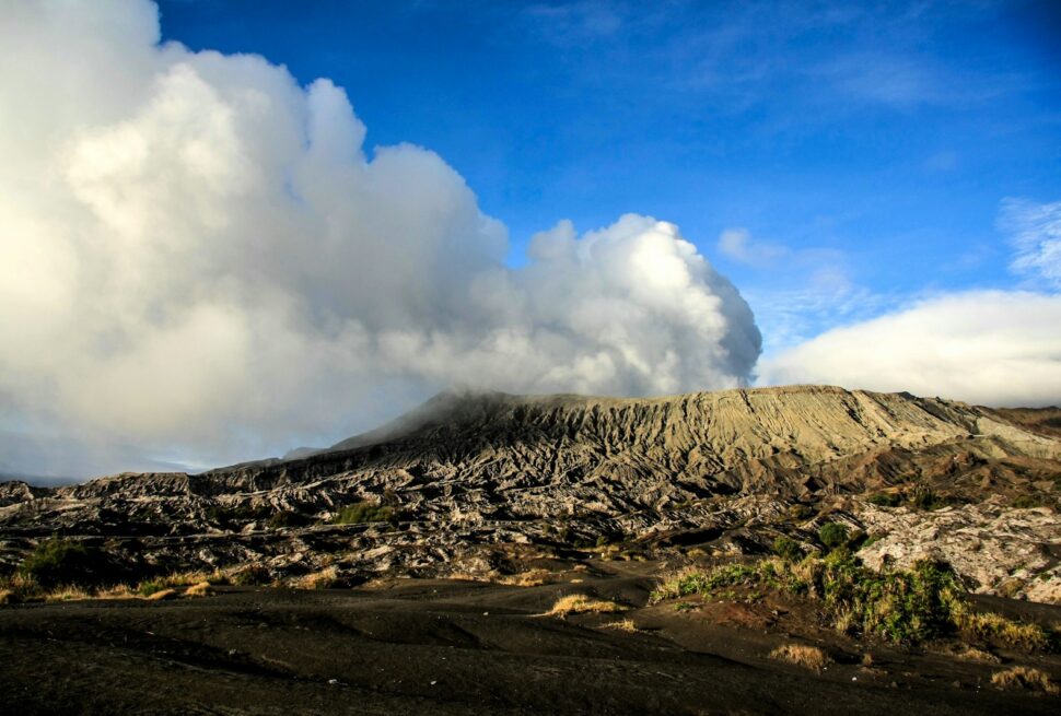 gray and black mountain under blue sky and white clouds during daytime