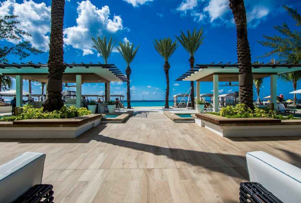 landscape photography of two pergolas near body of water