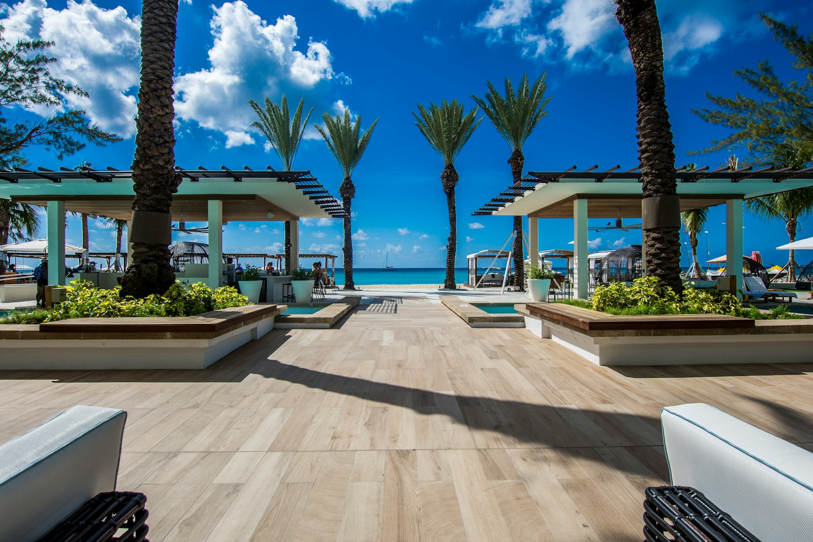 landscape photography of two pergolas near body of water