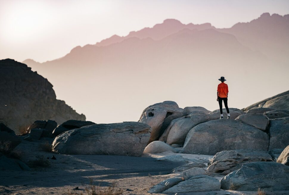 a person standing on top of a large rock